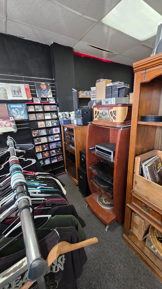Vertical frame of the audio gear corner with the clothing rack alongside