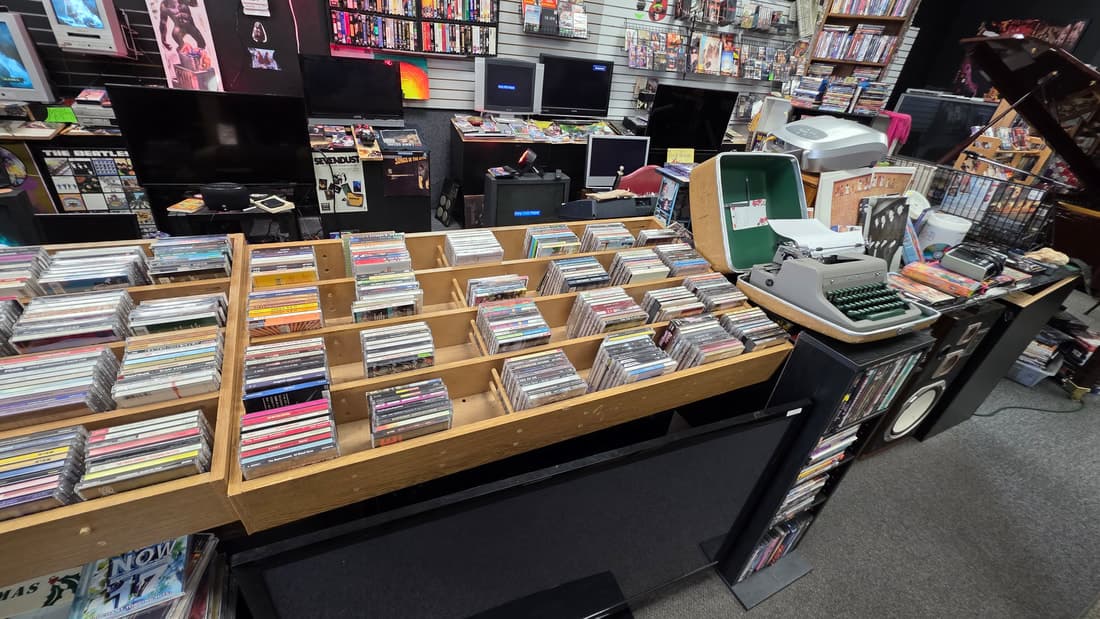 Wide view of the CD browser bins with a vintage typewriter sitting on the counter