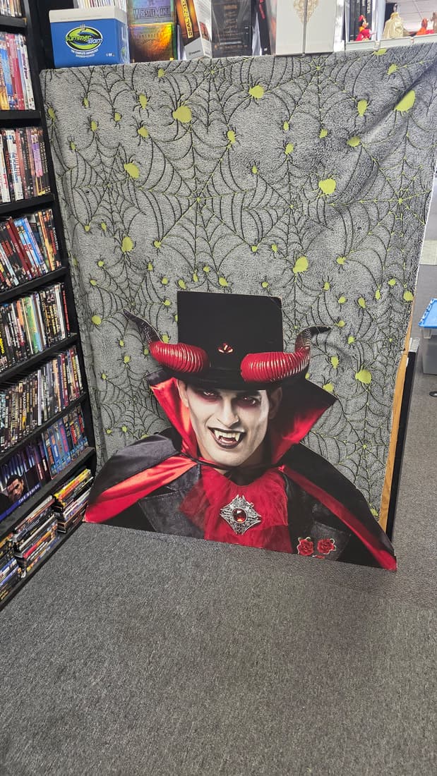 Vampire cardboard standee shot vertically beside the DVD aisle