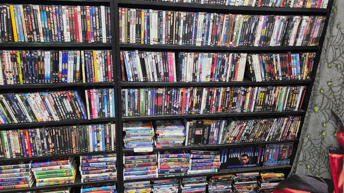 Wide frame of the DVD wall running the length of the room