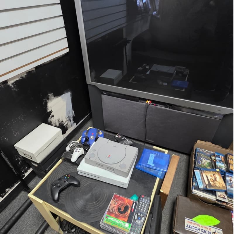 Retro video game shelf with boxed console titles and a PlayStation display