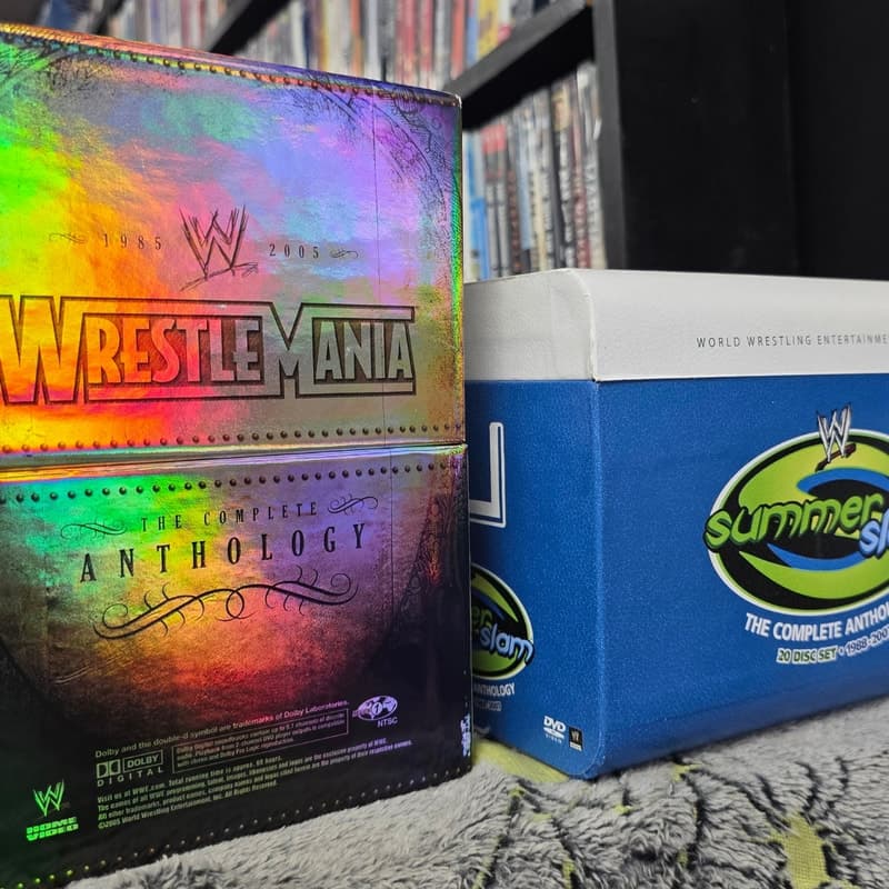 WWE WrestleMania and SummerSlam complete anthology DVD box sets displayed on a shelf